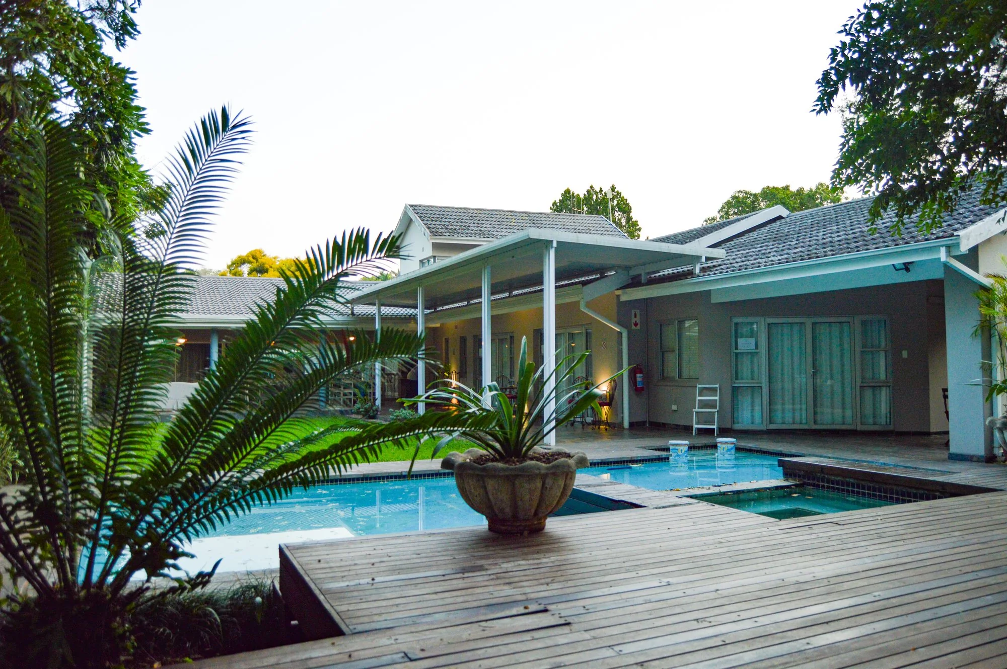 Yellowwoods Bed and Breakfast Empangeni — exterior and swimming pool at dusk Yellowwoods Bed and Breakfast Empangeni exterior seen across the lawn and swimming pool in the late afternoon