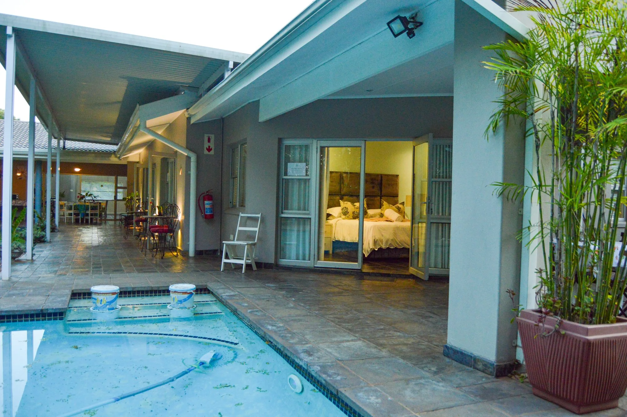Yellowwoods Bed and Breakfast Empangeni — pool deck and loungers Yellowwoods Bed and Breakfast Empangeni pool deck with sun loungers set among planted borders
