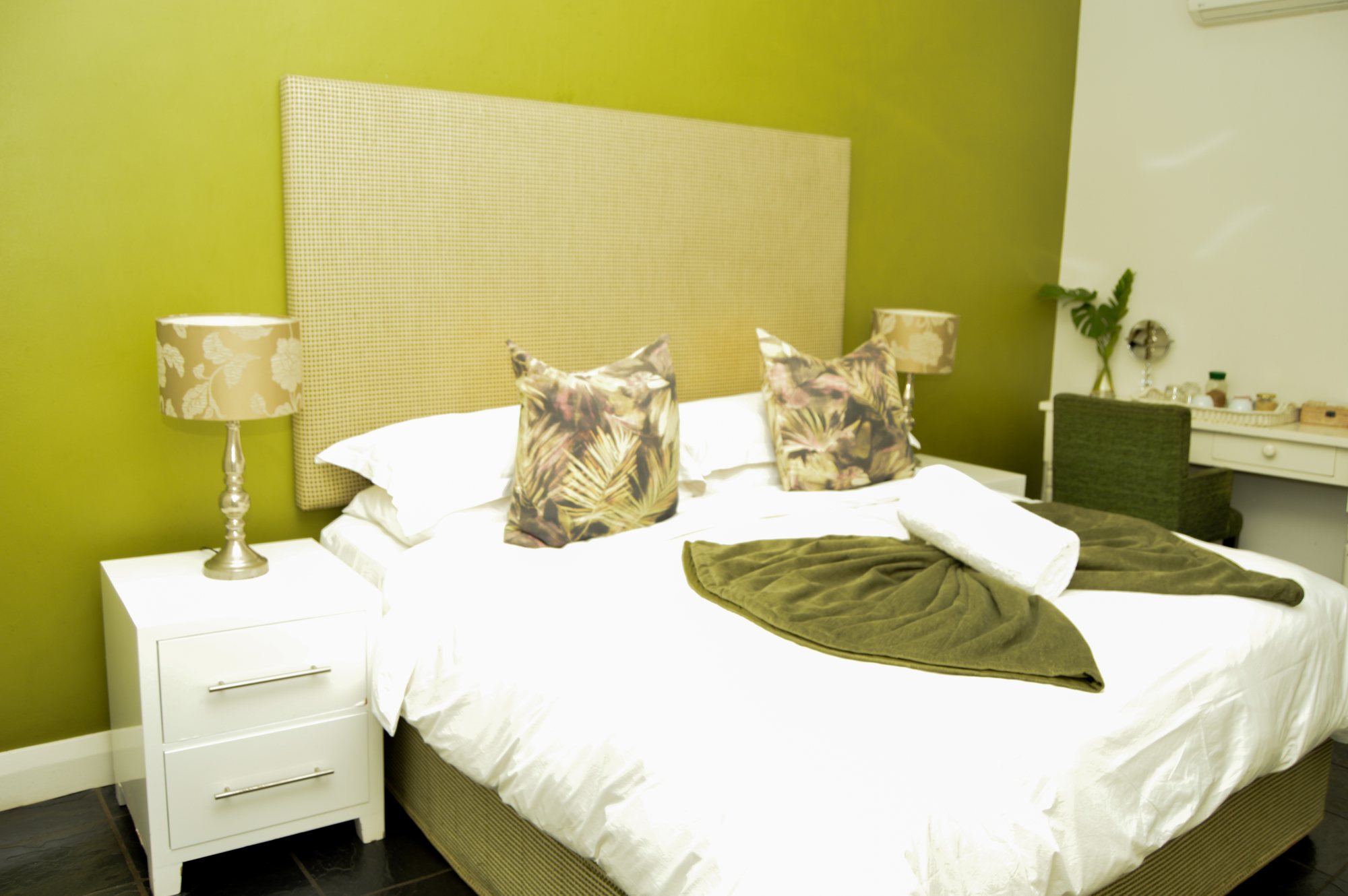 Room Three at Yellowwoods Bed & Breakfast with a green feature wall and white bedding